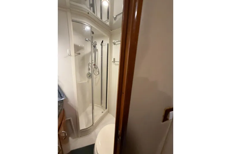 Orion Yacht Photos Pics Bathroom interior of 2004 Carver 460 Voyager yacht, featuring shower and toilet.