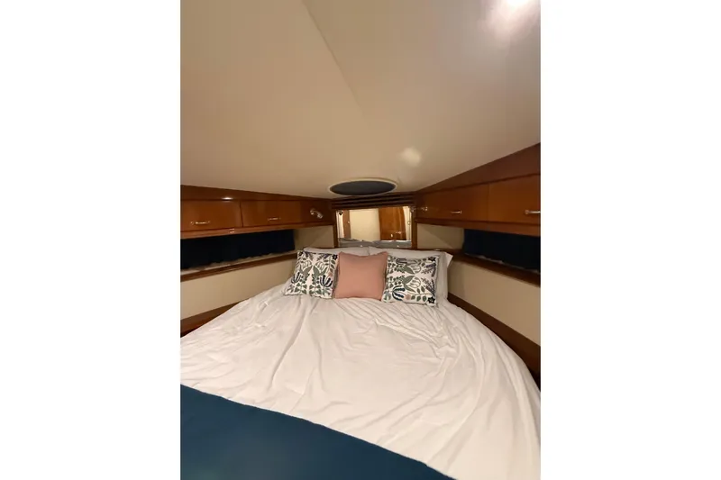 Orion Yacht Photos Pics Cozy bedroom interior of 2004 Carver 460 Voyager yacht with elegant wood cabinetry.