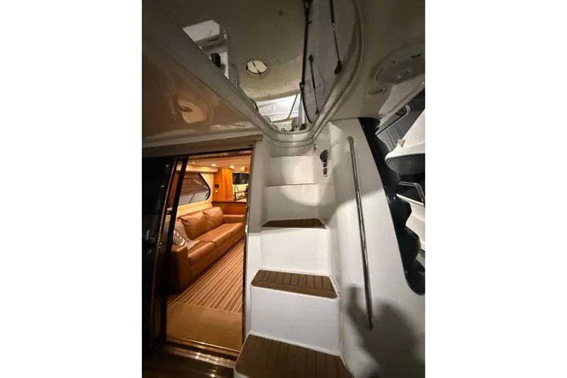 Orion Yacht Photos Pics Interior view of 2004 Carver 460 Voyager yacht, featuring stairs and cozy seating area.