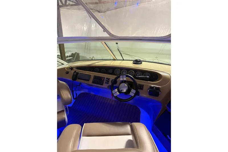 Orion Yacht Photos Pics Interior cockpit of 2004 Carver 460 Voyager yacht with illuminated controls and steering wheel.