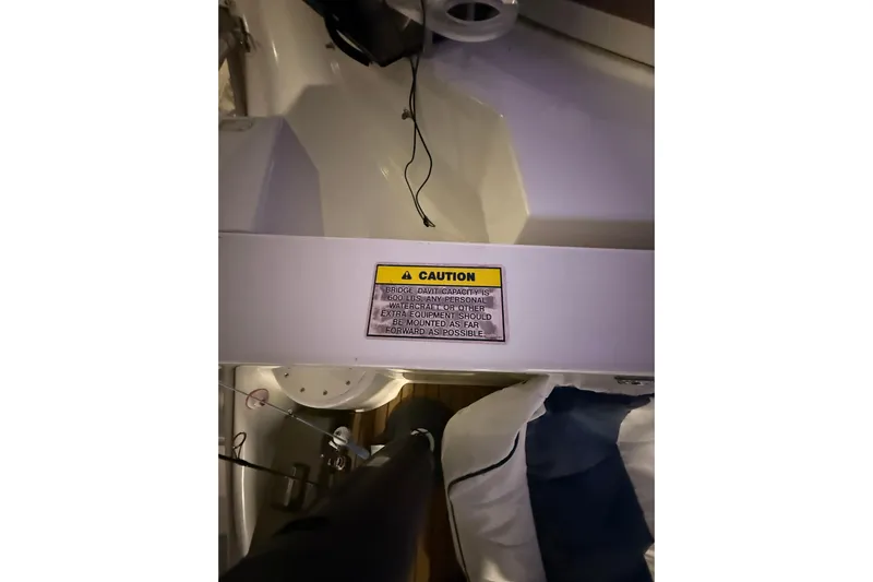 Orion Yacht Photos Pics Caution sign on 2004 Carver 460 Voyager boat, highlighting bridge davit capacity.