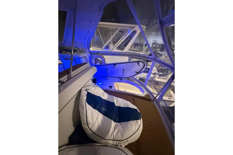 Orion Yacht Photos Pics 2004 Carver 460 Voyager yacht interior with blue ambient lighting and cushioned seating.