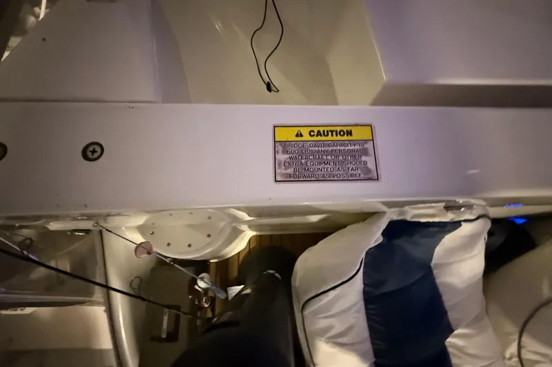 Orion Yacht Photos Pics 2004 Carver 460 Voyager interior with caution sign and equipment storage area.