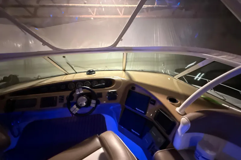 Orion Yacht Photos Pics Interior cockpit of 2004 Carver 460 Voyager yacht with illuminated dashboard and steering wheel.