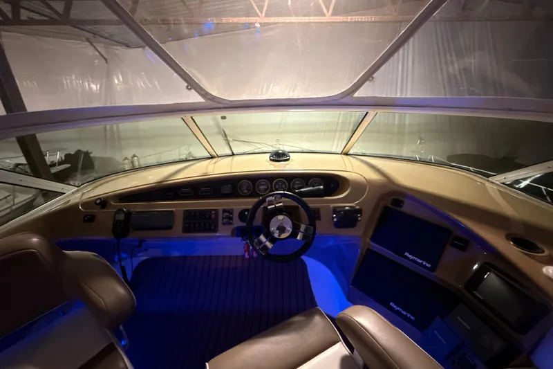 Orion Yacht Photos Pics Interior cockpit of 2004 Carver 460 Voyager yacht with illuminated controls and steering wheel.