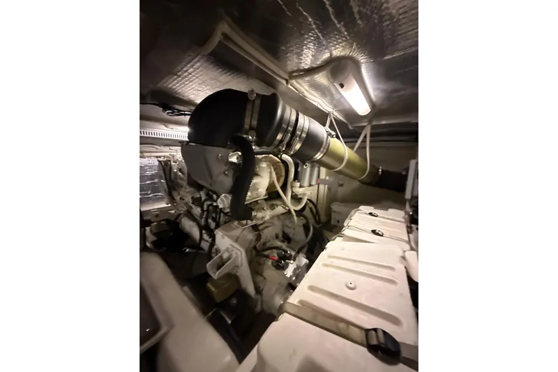 Orion Yacht Photos Pics Engine room of 2004 Carver 460 Voyager yacht, showcasing mechanical components and lighting.