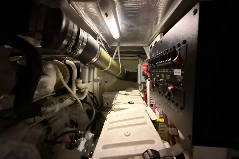 Orion Yacht Photos Pics Engine room of a 2004 Carver 460 Voyager yacht, showcasing mechanical components and control panel.