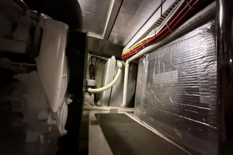 Orion Yacht Photos Pics Engine room of 2004 Carver 460 Voyager with insulated walls and visible piping.