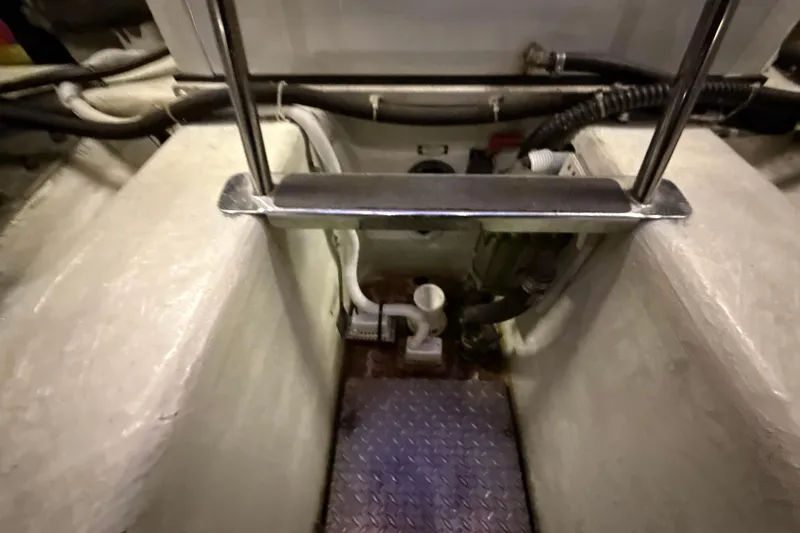 Orion Yacht Photos Pics Engine room of 2004 Carver 460 Voyager yacht with visible pipes and metal railing.