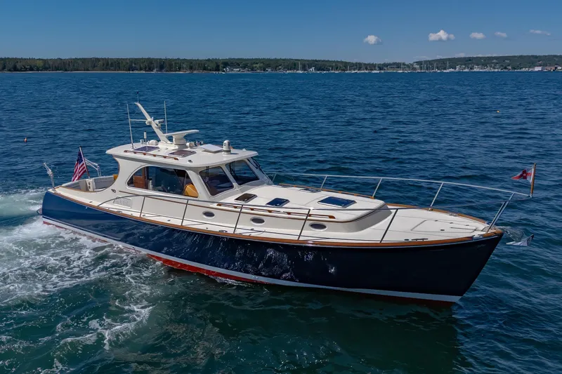 Maine Squeeze Yacht Photos Pics 2009 Hinckley Talaria 44 MY yacht cruising on open water under clear skies.