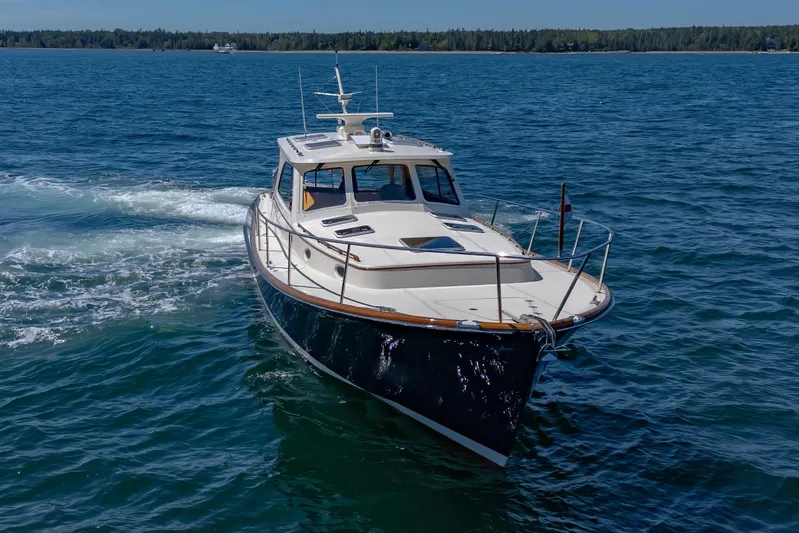 Maine Squeeze Yacht Photos Pics 2009 Hinckley Talaria 44 MY cruising on open water, showcasing elegant design and craftsmanship.