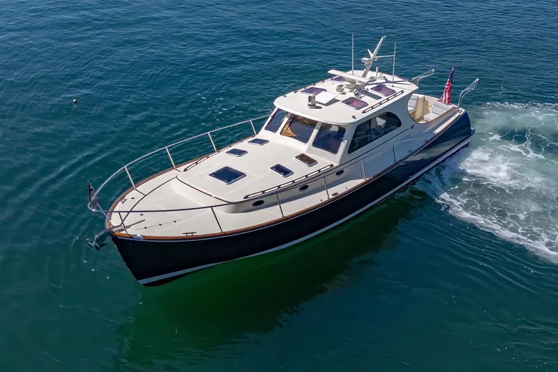 Maine Squeeze Yacht Photos Pics 2009 Hinckley Talaria 44 MY yacht cruising on clear blue water.