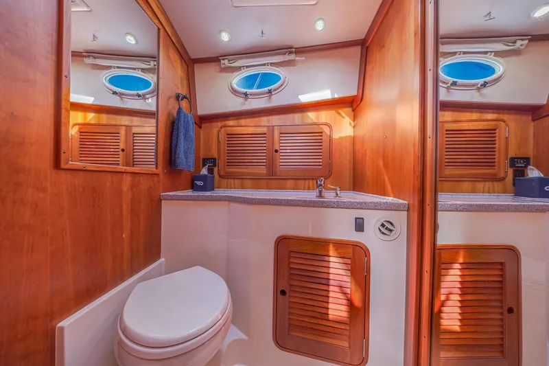 Maine Squeeze Yacht Photos Pics Luxurious 2009 Hinckley Talaria 44 MY yacht bathroom with wood accents and modern fixtures.