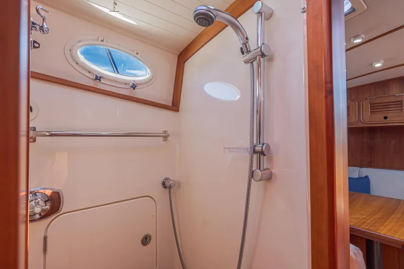 Maine Squeeze Yacht Photos Pics Luxurious shower area in 2009 Hinckley Talaria 44 MY yacht with wooden accents.