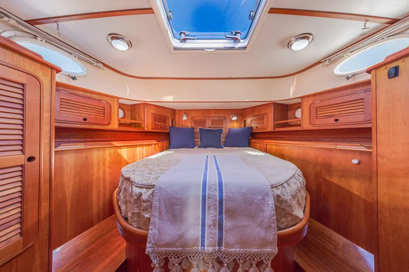 Maine Squeeze Yacht Photos Pics Luxurious cabin interior of 2009 Hinckley Talaria 44 MY yacht with wooden finishes.