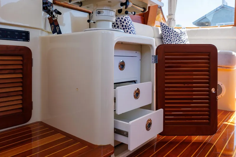 Maine Squeeze Yacht Photos Pics Interior of 2009 Hinckley Talaria 44 MY yacht with open wooden cabinet and drawers.