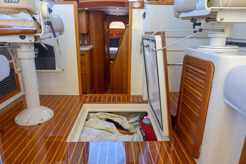 Maine Squeeze Yacht Photos Pics Interior of 2009 Hinckley Talaria 44 MY yacht with wooden flooring and storage compartment.