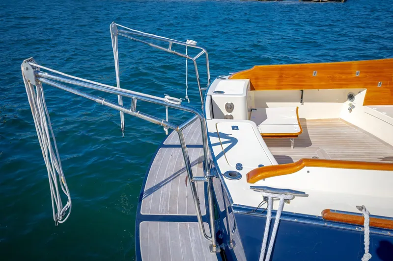 Maine Squeeze Yacht Photos Pics Hinckley Talaria 44 MY 2009 yacht deck with wooden accents and stainless steel railings.