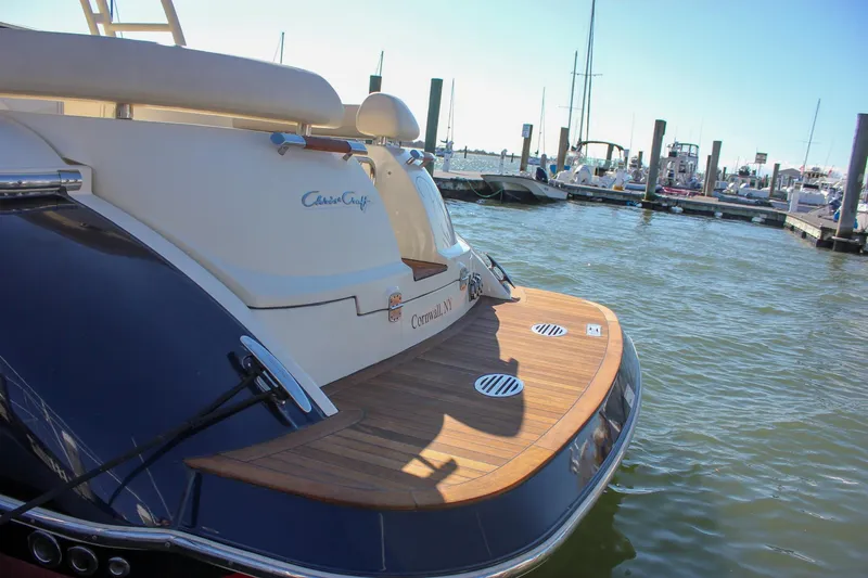 Phoenix Yacht Photos Pics 2017 Chris-Craft Launch 38 docked, showcasing elegant wooden deck and sleek design.