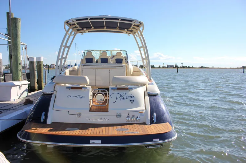 Phoenix Yacht Photos Pics 2017 Chris-Craft Launch 38 boat docked, rear view, sunny day, calm waters.