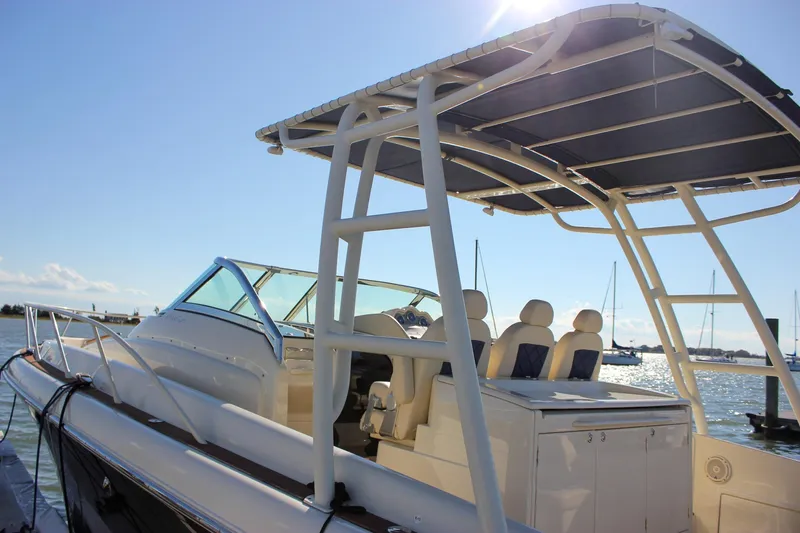 Phoenix Yacht Photos Pics 2017 Chris-Craft Launch 38 boat with seating and canopy, docked by the water.