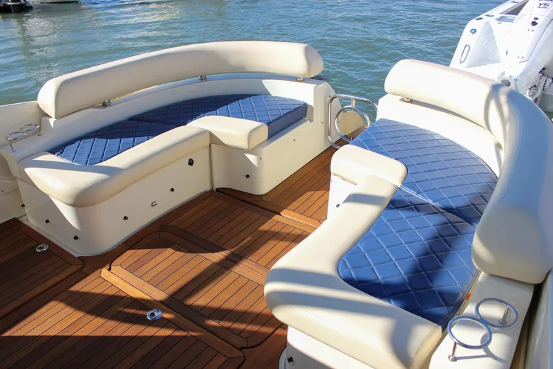 Phoenix Yacht Photos Pics 2017 Chris-Craft Launch 38 boat interior with blue cushioned seating and wooden deck.