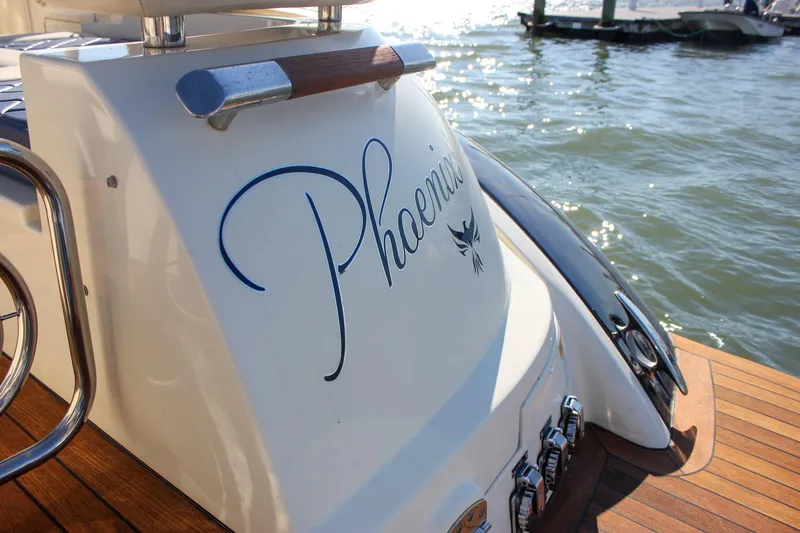 Phoenix Yacht Photos Pics 2017 Chris-Craft Launch 38 boat docked, featuring elegant wooden deck and stylish design.