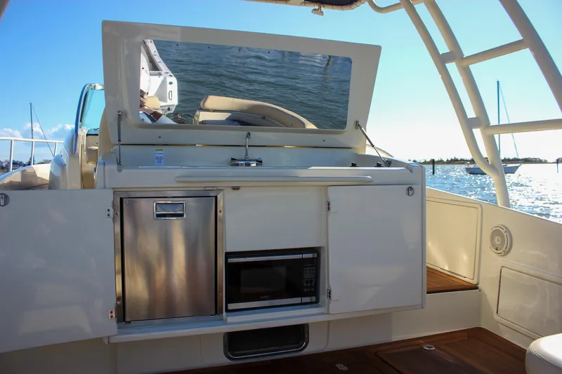 Phoenix Yacht Photos Pics 2017 Chris-Craft Launch 38 boat interior with kitchenette, featuring stainless steel appliances.