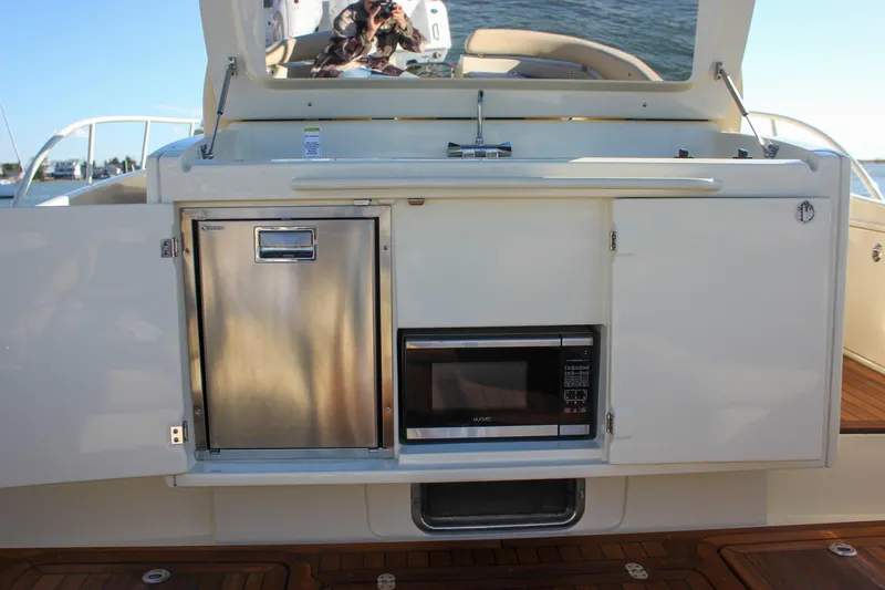 Phoenix Yacht Photos Pics 2017 Chris-Craft Launch 38 yacht kitchenette with stainless steel fridge and microwave.