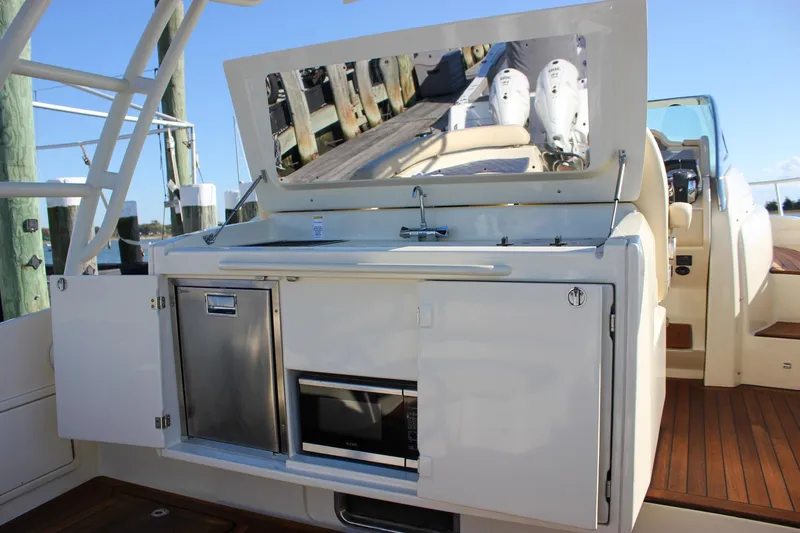 Phoenix Yacht Photos Pics 2017 Chris-Craft Launch 38 boat interior with kitchenette and wooden deck.