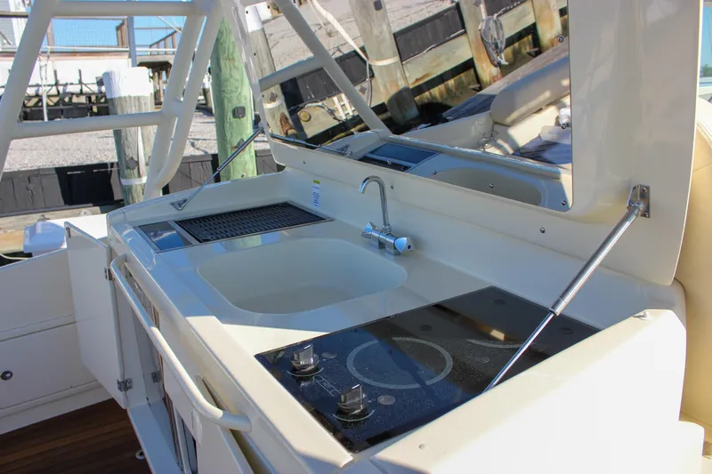 Phoenix Yacht Photos Pics 2017 Chris-Craft Launch 38 boat kitchen area with sink and stove, docked at marina.