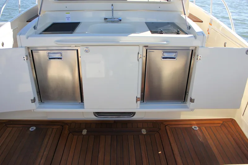 Phoenix Yacht Photos Pics 2017 Chris-Craft Launch 38 yacht kitchen with stainless steel appliances and wooden flooring.