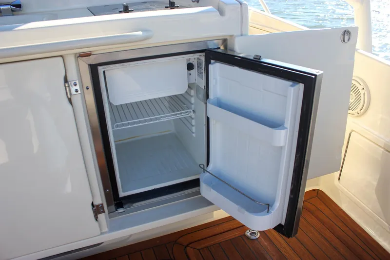 Phoenix Yacht Photos Pics Open refrigerator on 2017 Chris-Craft Launch 38 boat, showcasing interior storage space.