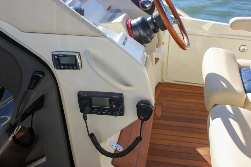 Phoenix Yacht Photos Pics Interior of 2017 Chris-Craft Launch 38 boat with steering wheel and communication devices.