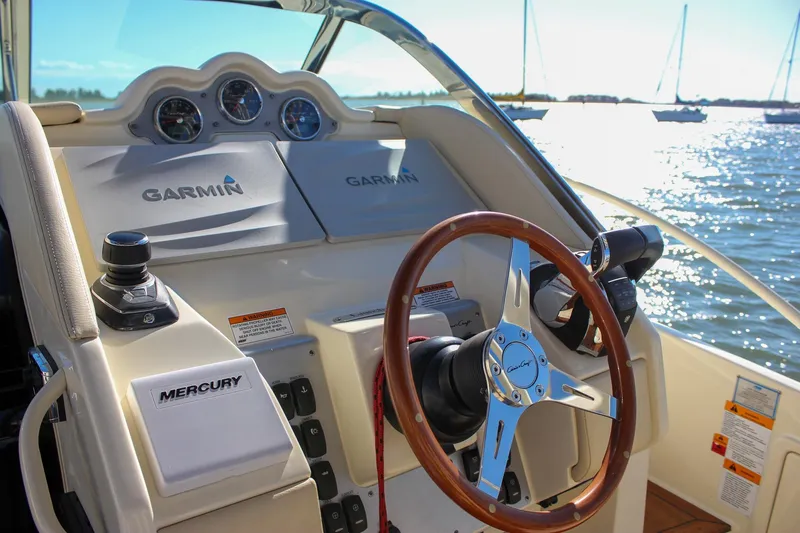 Phoenix Yacht Photos Pics 2017 Chris-Craft Launch 38 helm with Garmin navigation and Mercury controls on sunny waters.