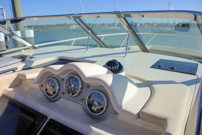 Phoenix Yacht Photos Pics 2017 Chris-Craft Launch 38 dashboard with gauges and compass, docked by the water.