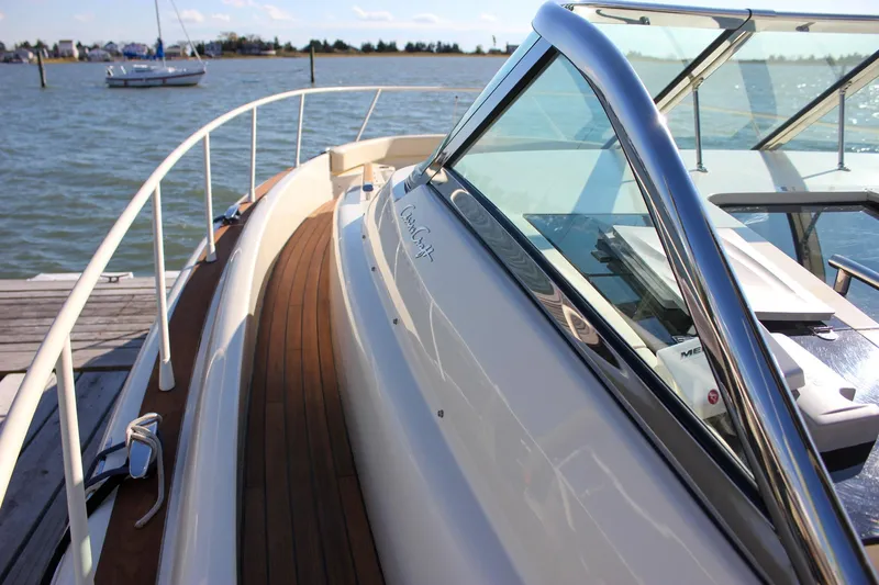 Phoenix Yacht Photos Pics 2017 Chris-Craft Launch 38 boat docked, showcasing sleek design and wooden deck.