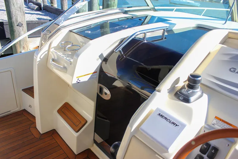 Phoenix Yacht Photos Pics 2017 Chris-Craft Launch 38 cockpit with wooden flooring and Mercury controls.