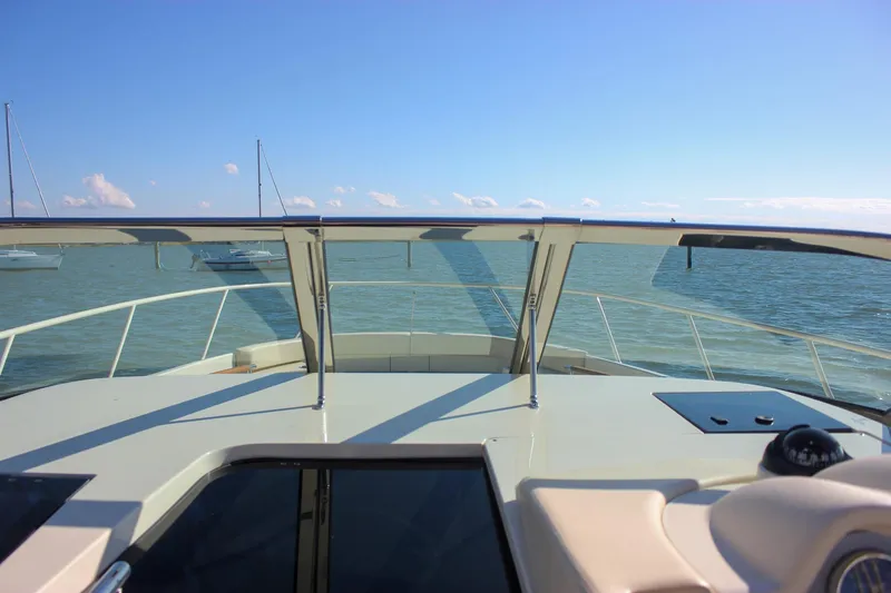 Phoenix Yacht Photos Pics 2017 Chris-Craft Launch 38 yacht on calm waters under clear blue sky.