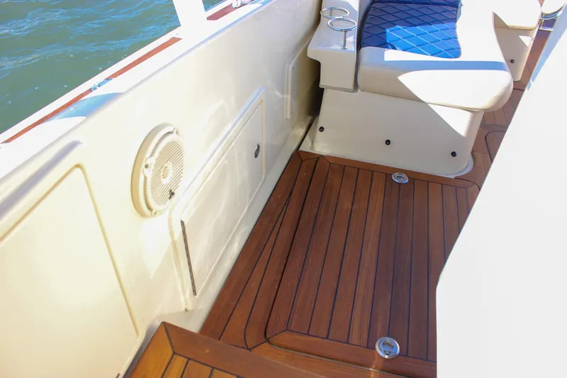 Phoenix Yacht Photos Pics 2017 Chris-Craft Launch 38 interior with teak flooring and cushioned seating.