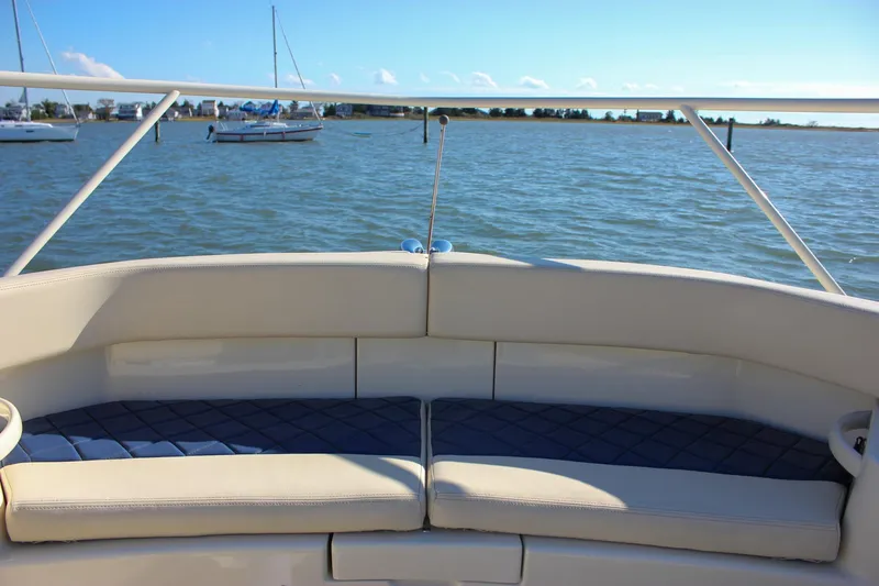 Phoenix Yacht Photos Pics 2017 Chris-Craft Launch 38 boat interior with cushioned seating, overlooking calm waters.