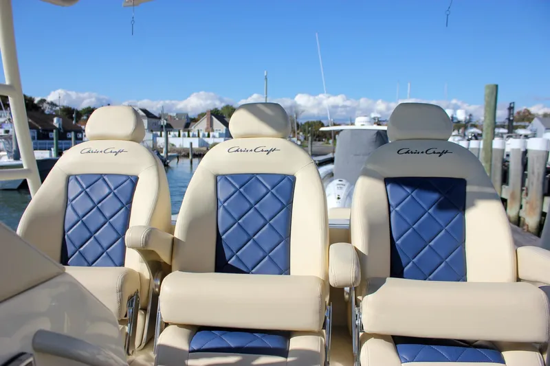 Phoenix Yacht Photos Pics Luxurious seating on 2017 Chris-Craft Launch 38 boat, featuring elegant blue and beige upholstery.