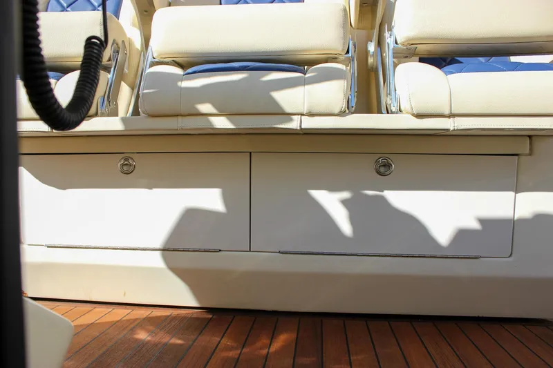 Phoenix Yacht Photos Pics 2017 Chris-Craft Launch 38 interior seating with storage, featuring elegant wood flooring.