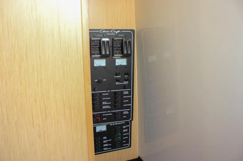 Phoenix Yacht Photos Pics Electrical control panel on a 2017 Chris-Craft Launch 38 boat, featuring various switches and indicators.
