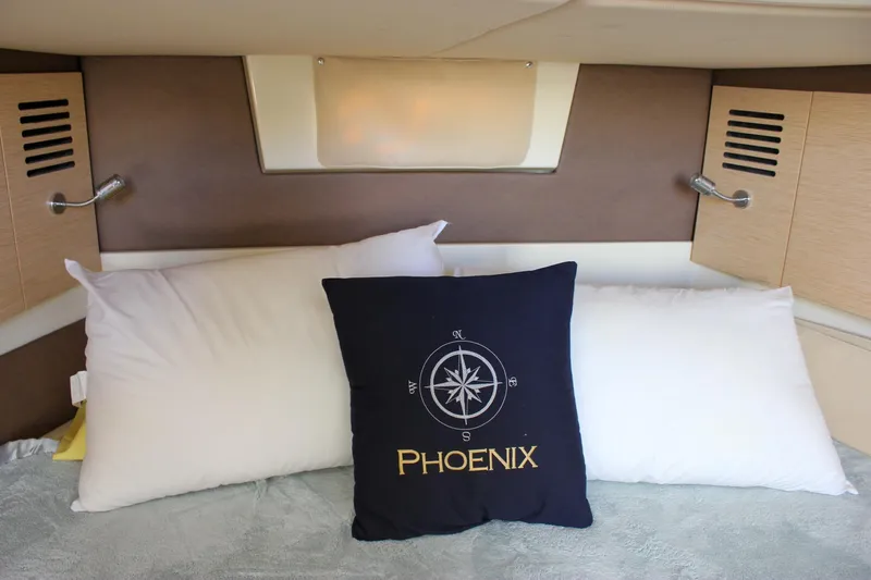 Phoenix Yacht Photos Pics Cozy cabin interior of 2017 Chris-Craft Launch 38 with decorative pillows.
