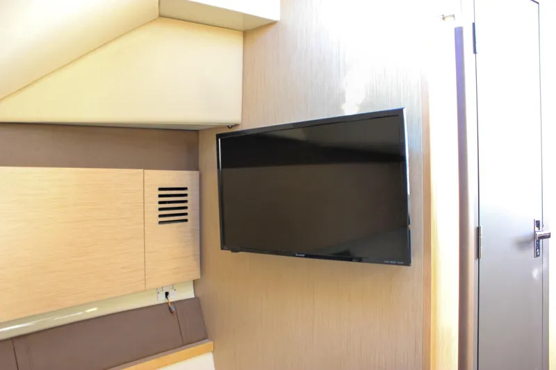 Phoenix Yacht Photos Pics 2017 Chris-Craft Launch 38 interior with mounted flat-screen TV.