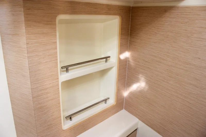 Phoenix Yacht Photos Pics 2017 Chris-Craft Launch 38 interior shelving with wood paneling and metal rails.