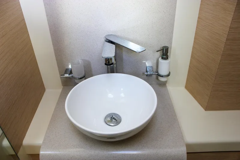 Phoenix Yacht Photos Pics Modern bathroom sink on 2017 Chris-Craft Launch 38 yacht, featuring sleek faucet and soap dispenser.