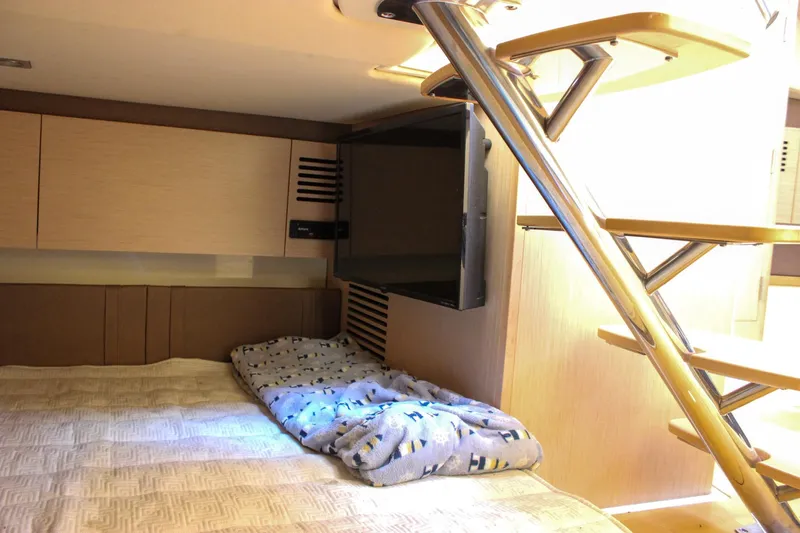 Phoenix Yacht Photos Pics 2017 Chris-Craft Launch 38 cabin interior with bed, TV, and modern staircase.