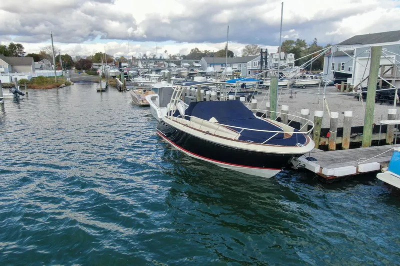 Phoenix Yacht Photos Pics 2017 Chris-Craft Launch 38 docked at a marina under cloudy skies.